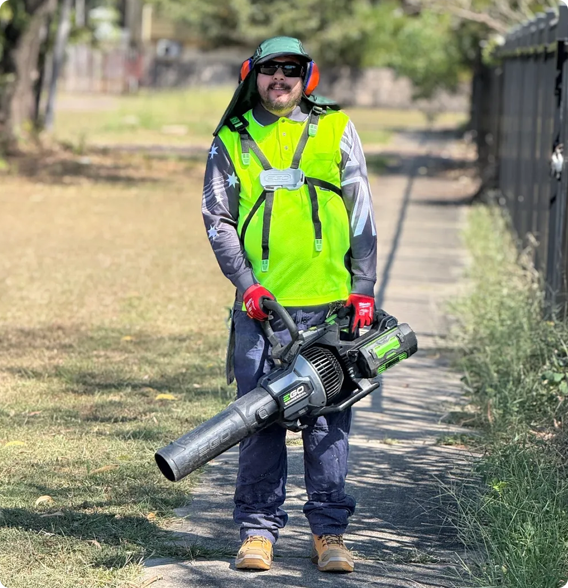 Man in safety gear holding leaf blower